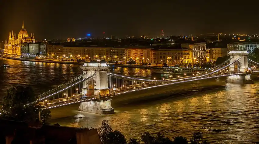 A budapesti Duna-part és a Széchenyi lánchíd esti fényben, a Sodrás Klub környéke.